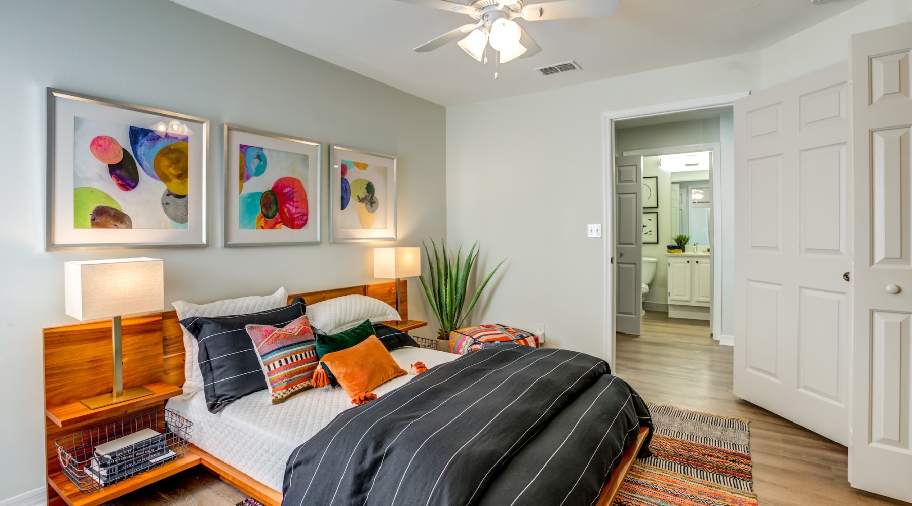a living room with a couch and a fan