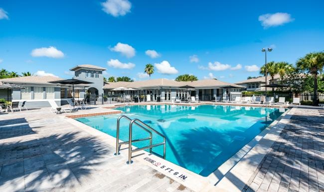 a swimming pool with buildings in the background