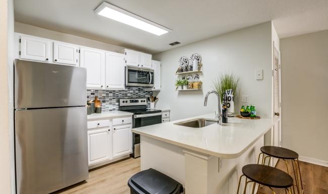 a kitchen with white cabinets