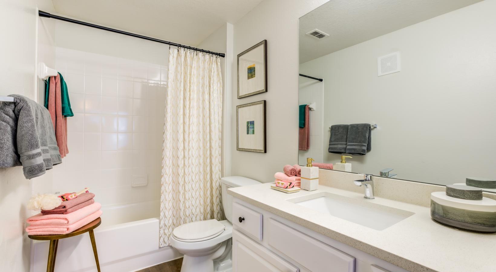 a bathroom with a sink toilet and a mirror