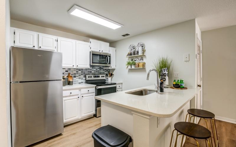 a kitchen with white cabinets