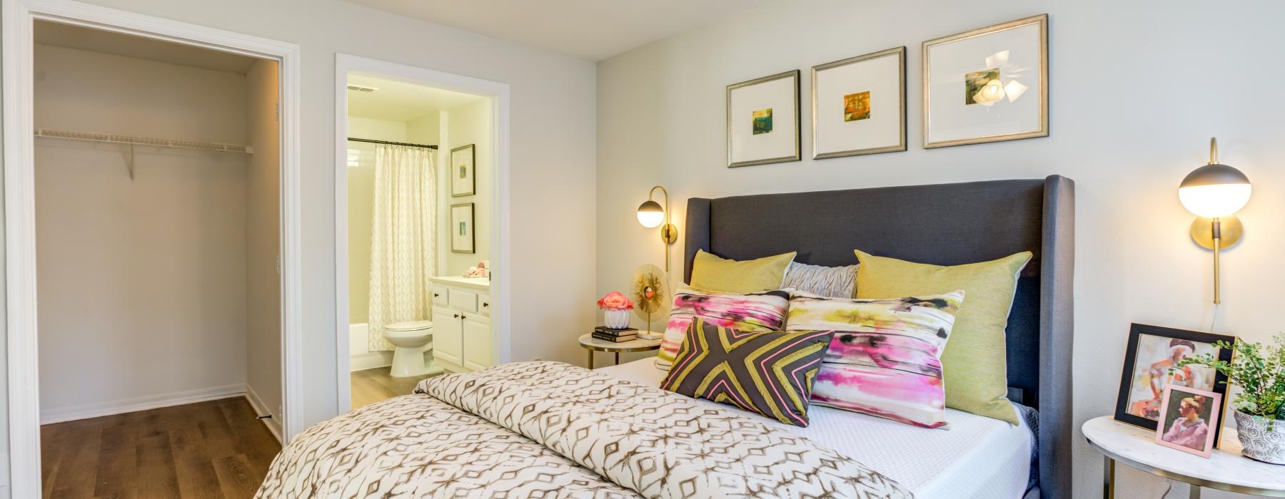 a bedroom with a bed and a fan